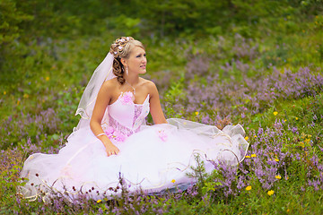 Image showing Beautiful bride is sitting in the forest