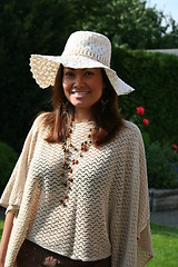 Image showing Beautiful lady in hat and poncho