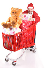 Image showing santa with Shopping cart with lots of presents isolated on white