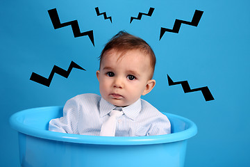 Image showing baby on a blue bucket, studio shoot, angry baby