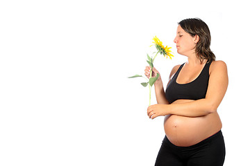 Image showing pregnant woman with beautiful belly and sunflower