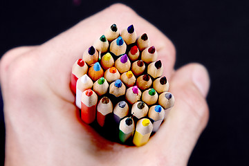 Image showing Assortment of coloured pencils with shadow on white/back backgro