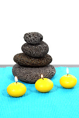 Image showing candles and massage stones in a calm zen spa