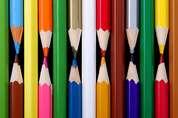 Image showing Assortment of coloured pencils with shadow on white/back backgro