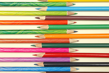 Image showing Assortment of coloured pencils with shadow on white background