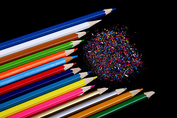 Image showing Assortment of coloured pencils with shadow on white/back backgro