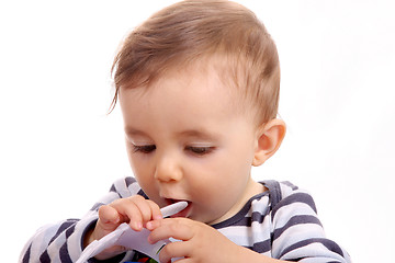 Image showing beautiful baby biting, baby studio photo