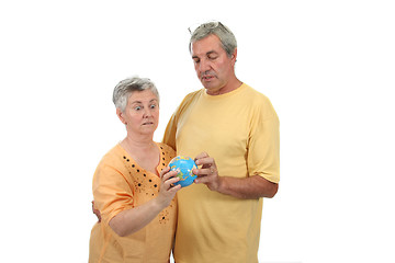 Image showing Mature couple plans vacations looking to the globe