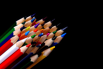 Image showing Assortment of coloured pencils with shadow on white/back backgro