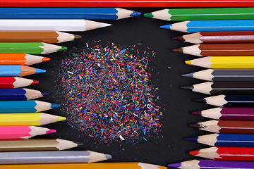 Image showing Assortment of coloured pencils with shadow on white/back backgro