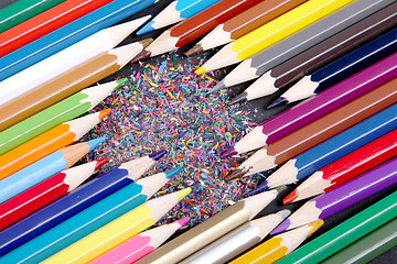 Image showing Assortment of coloured pencils with shadow on white/back backgro