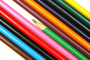 Image showing Assortment of coloured pencils with shadow on white background