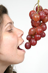 Image showing beautiful woman with red grapes, healthy food
