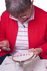 Image showing pensioner does embroidery