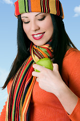 Image showing Attractive female shining a fresh apple