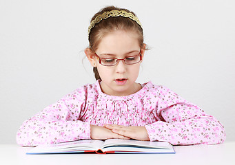 Image showing Schoolgirl with glasses reading book