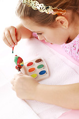 Image showing Child painting Easter eggs