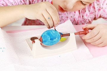 Image showing Child painting Easter eggs