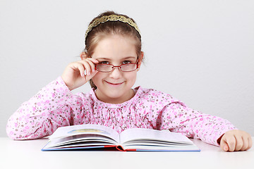 Image showing Schoolgirl with glasses reading book