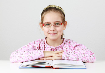 Image showing Schoolgirl with glasses reading book