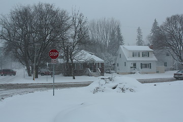 Image showing  Picture taken during a winter storm that passed by the city - pile of snow at the corner