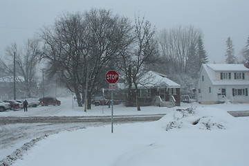 Image showing Picture taken during a winter storm that passed by the city - snow  covered a busy intersection