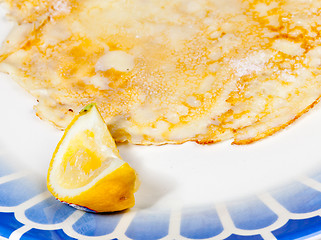 Image showing Pancake with lemon on blue plate