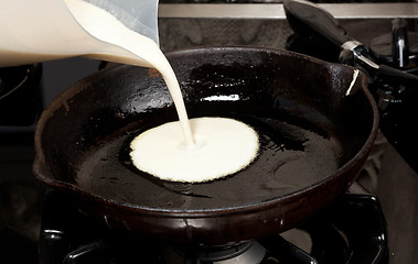 Image showing Pouring pancake mix into frying pan