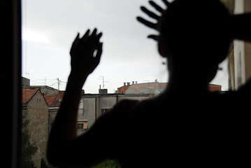 Image showing Female silhouette by window