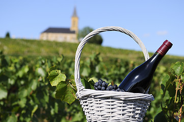 Image showing bottle of red wine in countryside