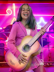 Image showing Happy teen girl with guitar