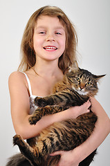 Image showing happy child holding a cat in hands