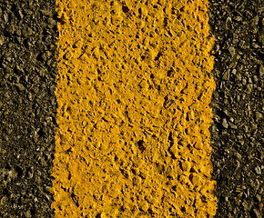 Image showing asphalt yellow road markings macro background 