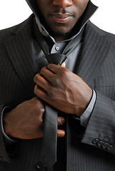 Image showing Business man fixing his tie