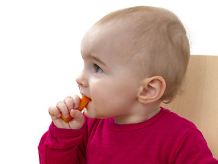 Image showing child in red shirt eating