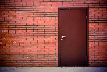 Image showing Red brick wall and the iron closed door