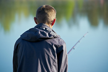 Image showing fisher on a morning foggy lake