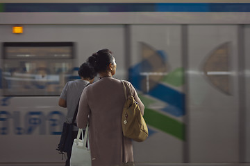 Image showing woman and a train passing by