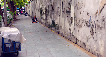 Image showing Homeless Man bundled sleep in a city doorway