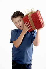 Image showing Child shaking a wrapped present