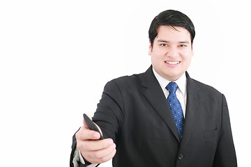 Image showing Handsome young man in a suit giving you a mobile