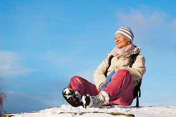 Image showing woman sitting outdoors and enjoy the Sun