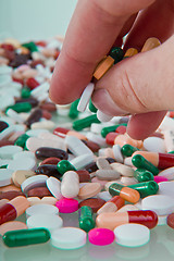 Image showing hand grabbing pills