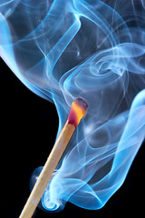 Image showing Photo of a burning match in a smoke on a black background 