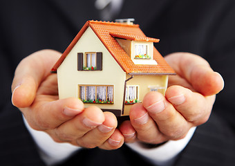 Image showing Hand of the businessman with the house