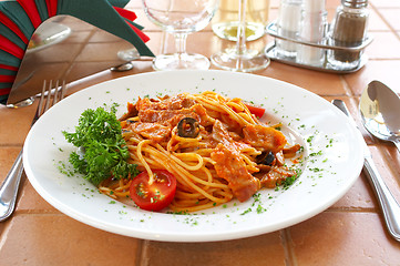 Image showing Spaghetti with a tomato sauce on a table in cafe