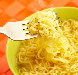 Image showing Hot and tasty noodles on a plug.