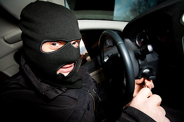 Image showing robber and the thief in a mask hijacks the car