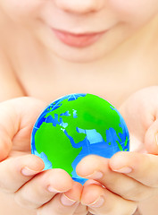 Image showing boy holds globe in hands