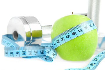 Image showing Dumbbells and apple. A healthy way of life